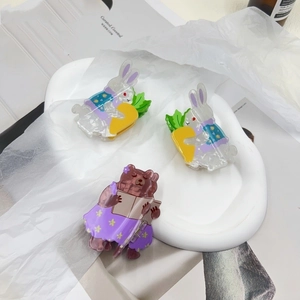 Detailed view of cute acrylic animal hair clips featuring rabbits and a teddy bear