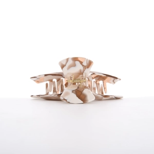 Close-up of acetic acid hair claw clip with brown marble pattern and golden metal spring