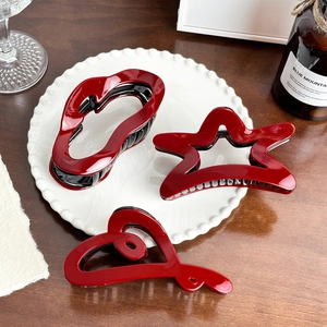 Red heart star and lip hair claws set in polished finish for elegant hairstyling