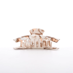 Detailed macro view of large milk tea marbled acetate hair claw with durable metal spring