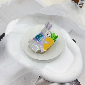 Detailed macro view of cute acrylic rabbit hair claw clip with carrot decoration