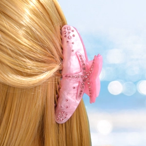 Pink starfish hair claw clip with rhinestones for women on elegant blonde hair