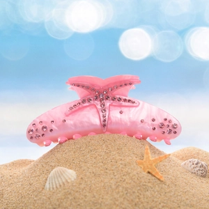 Detail of pink rhinestone starfish hair claw clip made of marble texture acrylic