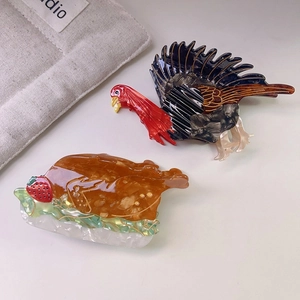 Macro detail of acetate turkey hair claw clips with colorful patterns and glossy finish
