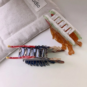 Close-up of acetic acid shark clips in creative chicken leg and sandwich food designs