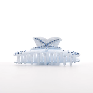 Detail of light blue starfish hair claw clip with dark blue rhinestones on white background
