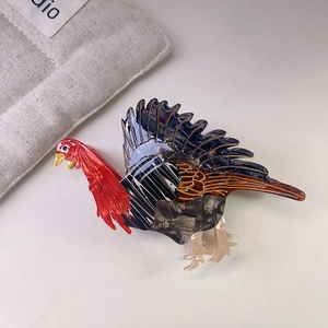 Macro detail of turkey-shaped acetate hair claw clip showing fine textures and glossy finish