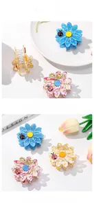 Close-up of daisy acetate hair claws with ladybug details on elegant display plates
