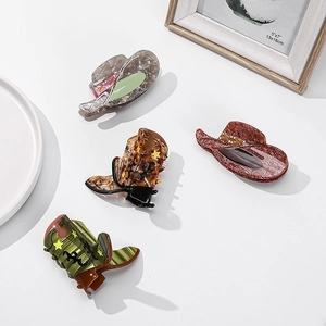 Set of four western cowboy hat and boot acetate hair claws with marble and star patterns