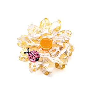 Floral acetate hair claw clip in sunflower design with a small pink ladybug decoration