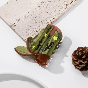 Green and brown western boot hair claw clip with star motif on a neutral background