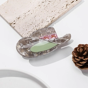 Detail of cellulose acetate hair claw clip in a unique vintage hat shape design