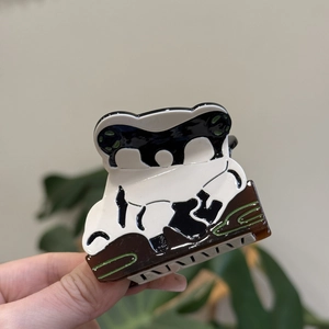 Detail of a panda-shaped acetic acid hair claw clip with colorful resin patchwork