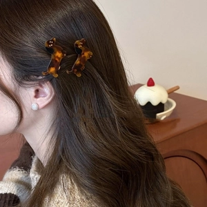 Cute dachshund hair clips set with brown tortoiseshell pattern worn by a model