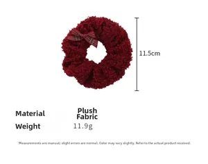 Detail view of burgundy plush scrunchie with red plaid bow, weighing 11.9g and 11.5cm wide