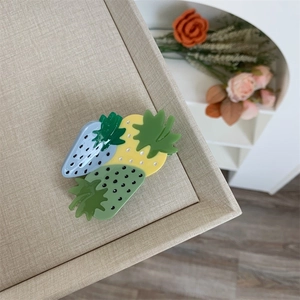 Close-up of strawberry hair claw clip in pastel colors made of premium acetate material