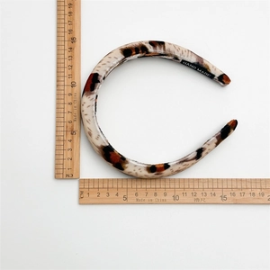 Retro leopard print velvet headband for women with handmade label on white background