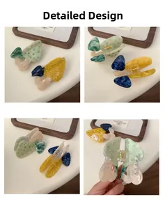 Vue détaillée des pinces à cheveux papillon en acétate avec des strass scintillants