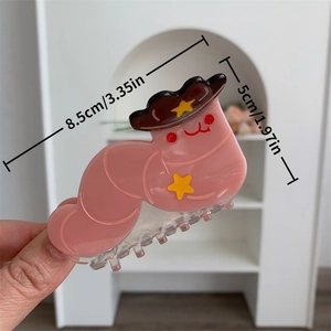 Detailed view of pink caterpillar acetate hair claw with size labels in centimeters
