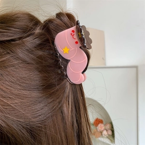 Cute pink caterpillar acetate hair claw with yellow star and smiley face on wavy hair
