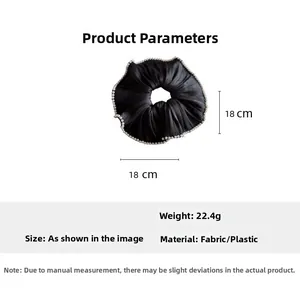 Detail view of large black satin hair scrunchie with pearl trim showing 18cm diameter size