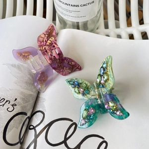 Elegant butterfly acetate hair claws with marble texture and rhinestones for styling