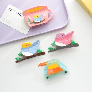Chic acetate bird hair claws and pink coffee cup shark clip detail in vibrant colors