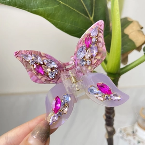 Pink and purple butterfly hair claw clip with marble patterns and sparkling crystals