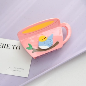Detail of pink coffee cup hair claw with bird pattern and smooth resin texture finish