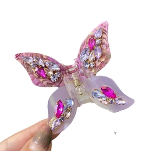 Handcrafted butterfly hair claw with purple acetate wings and sparkling rhinestones
