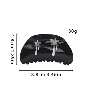 Detailed view of a black glossy hair claw clip with silver stars, measuring 8.8cm in size