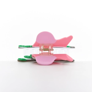 Detail view of the pink and green acetate butterfly hair claw with silver metal spring