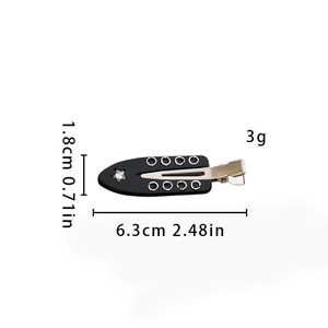 Detail view of a 6.3cm punk style black hair clip with silver eyelets and a star