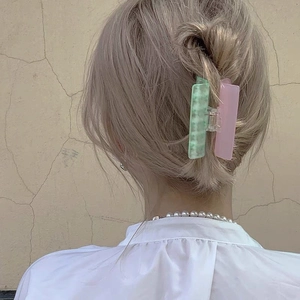 Minimalist large hair claw clip in mint green marble and matte pink dual-color design