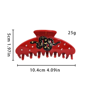 Elegant red acetate hair claw with rhinestone snake motif and star moon engraving