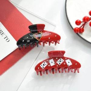 Detailed macro view of creative poker card and heart pattern claw clips with rhinestones