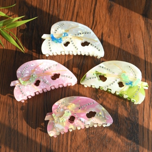 Elegant rhinestone leaf claw clips in acetate marble patterns for women's hair styling