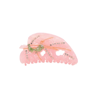 Elegant pink acetate hair claw clip with rhinestones and leaf design on white background