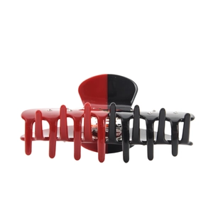 Close-up of red and black split acetate hair claw clip with sparkling rhinestones