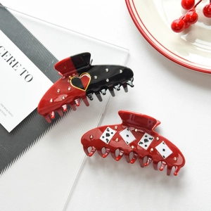 Detailed view of poker theme acetate hair claws with rhinestones and heart patterns