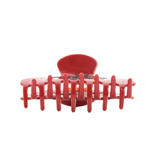 Close-up of red acetic hair claw clip with rhinestones and black butterfly pattern