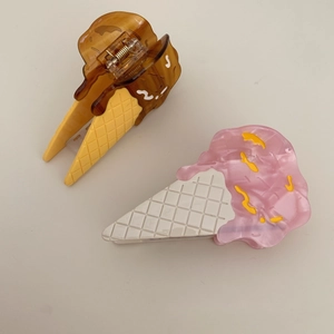 Detail shot of acetate hair claws featuring cream cone and strawberry ice cream designs