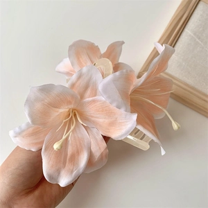Detailed view of the 3D lily flower hair claw clip with realistic petals and resin base