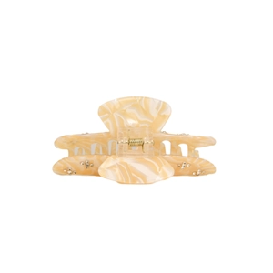 Detailed macro view of cream marble acetate hair claw clip with rhinestones and gold spring