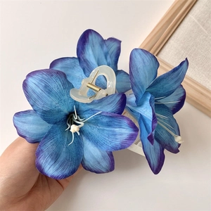 Detail of large blue lily flower hair claw clip with realistic silk gradient petals
