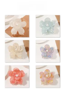 Six pearl flower hair claws in cream, blue, purple, and orange acetate finishes