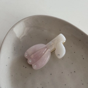 Detailed macro view of pink acetate tulip hair clip with sparkling rhinestones decoration