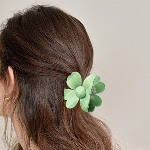 Cute green checkered flower hair claw clip shown in a stylish half-up hairstyle