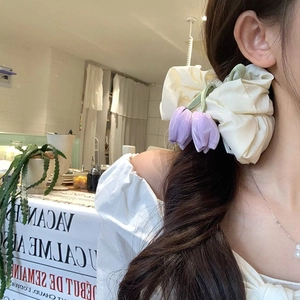 Chic off-white scrunchie with purple tulip floral accents for elegant ponytails