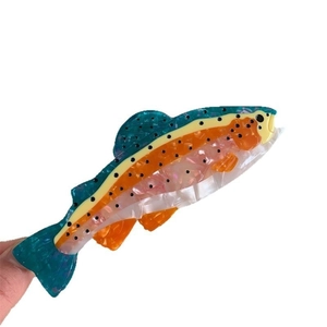 Colorful fish-shaped acetate hair claw clip with vibrant marbled pattern for women